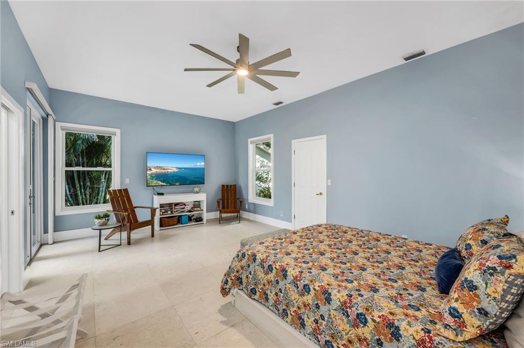 2041 Prince Drive Naples, FL 34110 - Photo 19 of 31 a bedroom with a bed and a large window