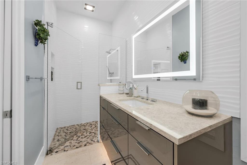 2041 Prince Drive Naples, FL 34110 - Photo 20 of 31 a bathroom with a sink and a mirror