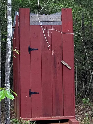 an aerial view of a house with garden space and wooden fence