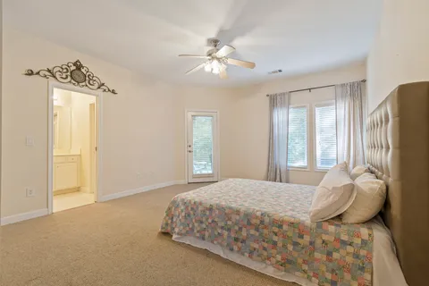 a bedroom with a large bed and a chandelier