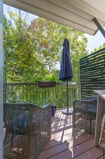 a view of a two chairs and table in the balcony