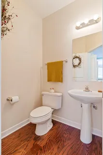 a bathroom with a sink toilet and mirror