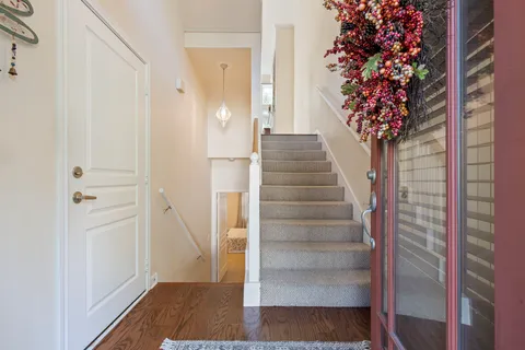 a view of entryway with wooden floor and stairs
