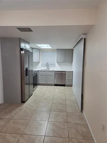 a large kitchen with cabinets and stainless steel appliances