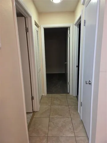 a view of a small space with wooden floor and a window