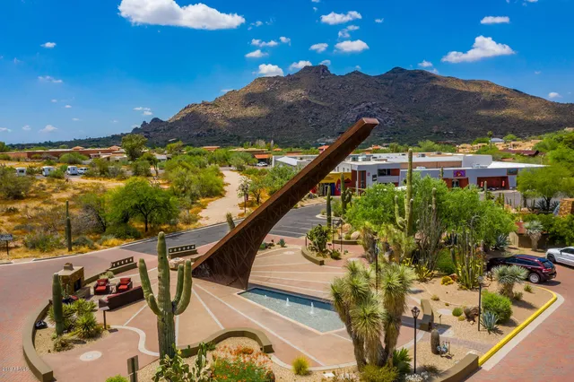 a view of a swimming pool with a yard and mountain view