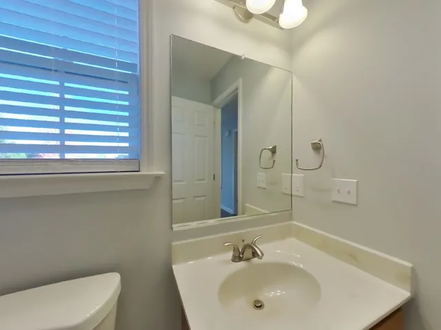 a view of a house with a yard and deck