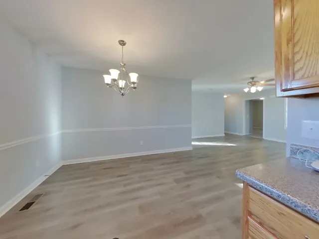a view of a livingroom with a chandelier fan