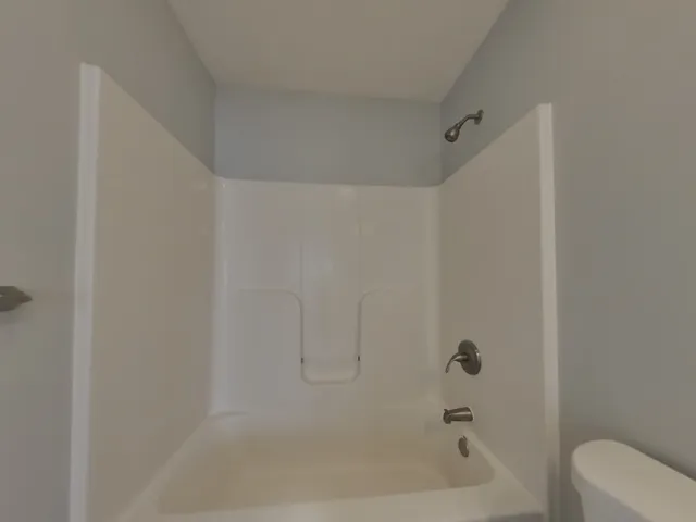 a bathroom with a bathtub and toilet