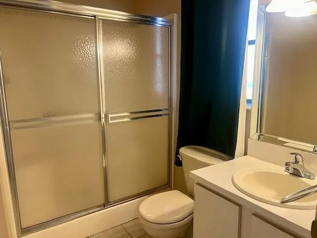 a white toilet sitting next to a bathroom sink