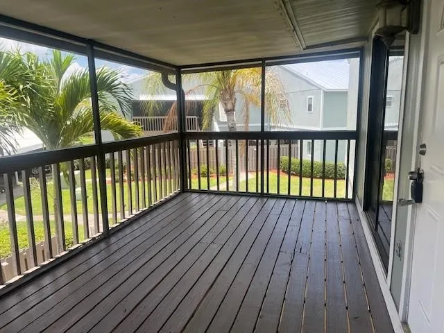a view of wooden balcony with wooden floor