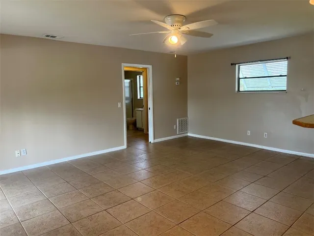 a view of an empty room with glass door