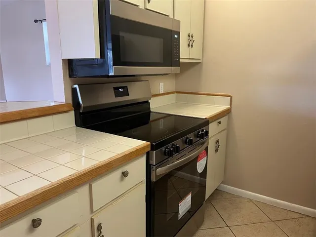 a kitchen with a stove and a microwave
