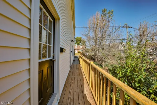 a view of a balcony with wooden floor and fence