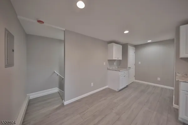 a view of a kitchen with a sink and a refrigerator