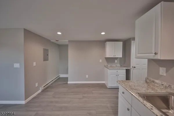 a kitchen with a sink stove and cabinets