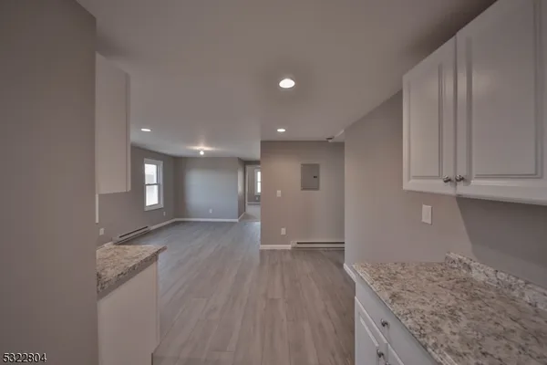 a view of hallway with wooden floor