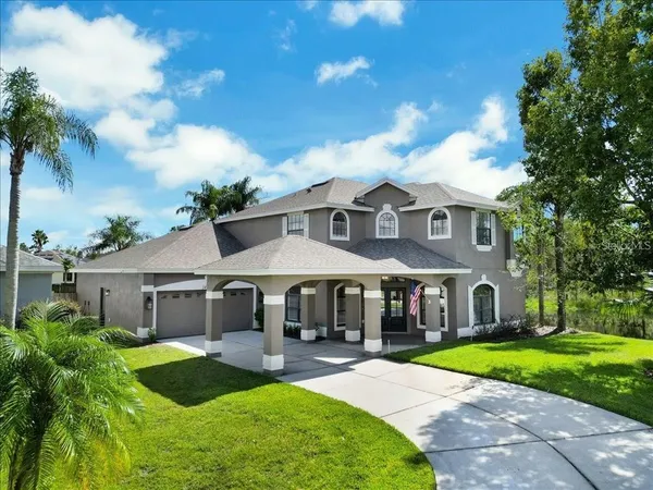 a front view of a house with yard and green space