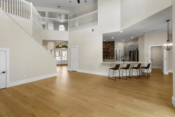 a view of a livingroom with furniture and a kitchen