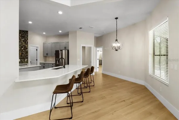 a view of a kitchen with kitchen island dining table and wooden floor