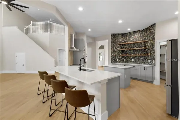 a kitchen with stainless steel appliances kitchen island granite countertop a sink and cabinets