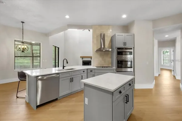 a kitchen with a sink stove and refrigerator