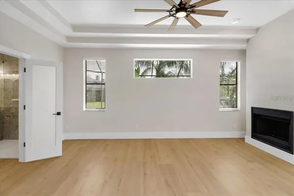 a view of a livingroom with a ceiling fan and window