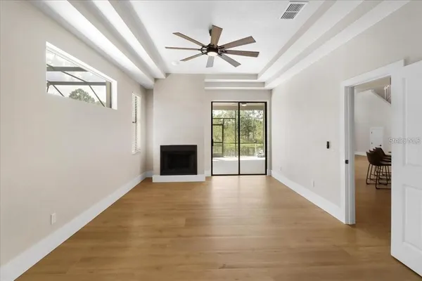 wooden floor in an empty room with a fireplace