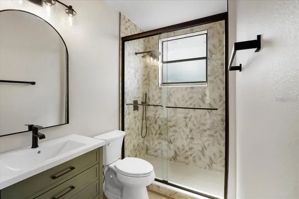 a bathroom with a sink toilet and shower