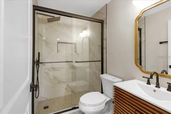 a white toilet sitting next to a bathroom sink