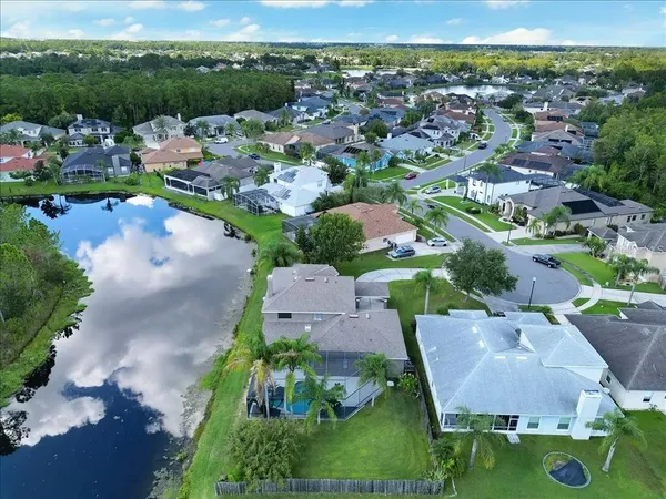 an aerial view of a houses with a yard