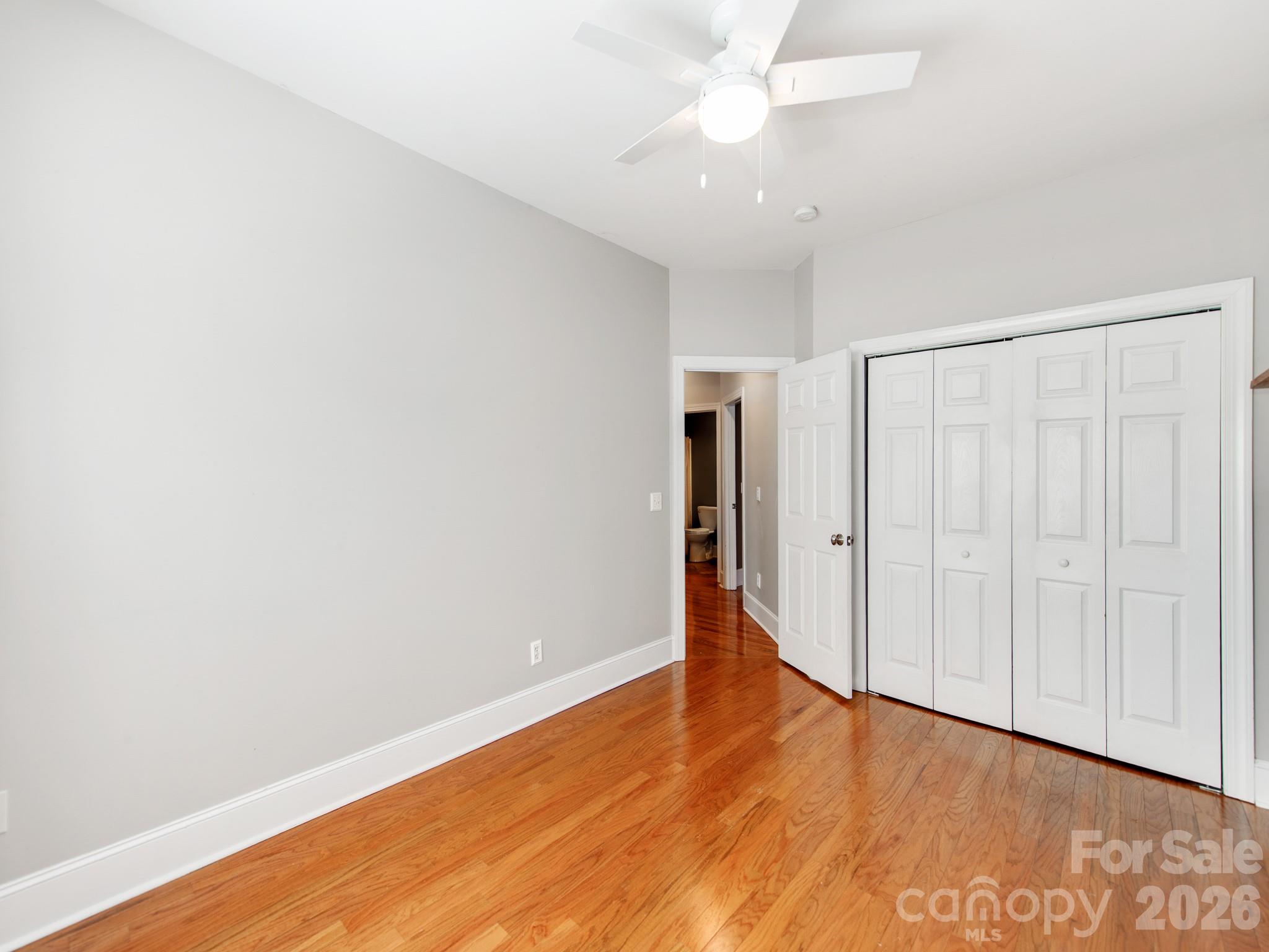 783 Sloan Street Denver, NC 28037 - Photo 22 of 44 a view of an empty room with wooden floor