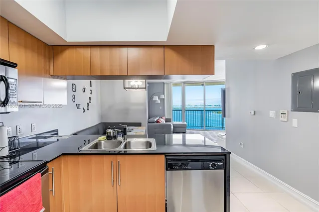 a kitchen with granite countertop a sink and a stove top oven