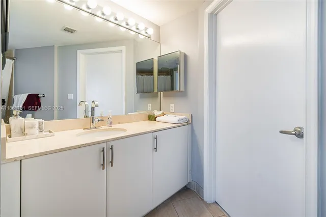 a bathroom with a double vanity sink and mirror