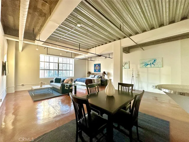 a view of a dining room with furniture and window