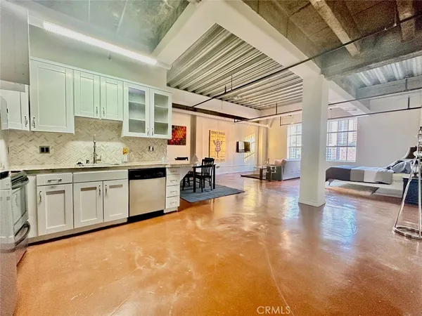 a large white kitchen with a large window