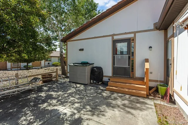 a view of backyard with deck and outdoor seating