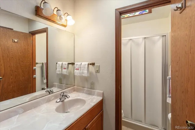 a bathroom with a shower a toilet and sink