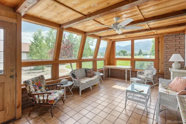 a living room with furniture and large windows