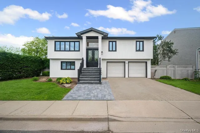 a front view of a house with a garden and yard