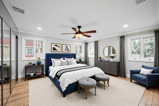 a bedroom with a bed and a large window