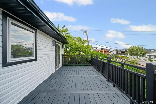 a view of a balcony with wooden floor