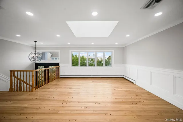 a view of kitchen with cabinets wooden floor and a sink