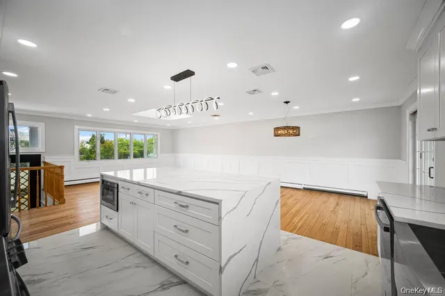 a view of a room with wooden floor and windows