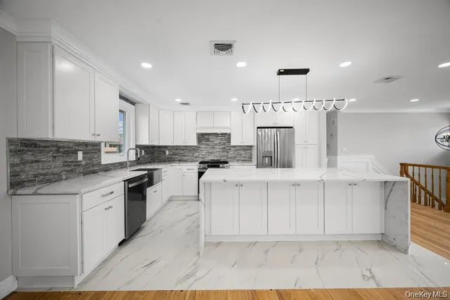 a kitchen with stainless steel appliances granite countertop a sink and a stove