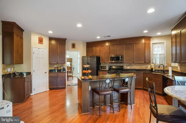 a large kitchen with a table and chairs