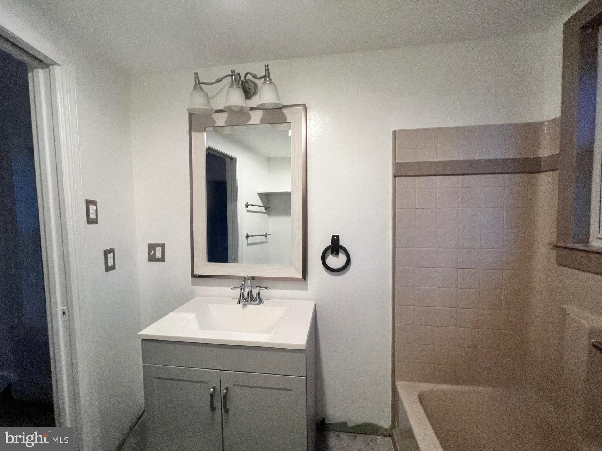 302 West Main Street Millville, NJ 08332 - Photo 11 of 22 a bathroom with a sink a toilet and shower