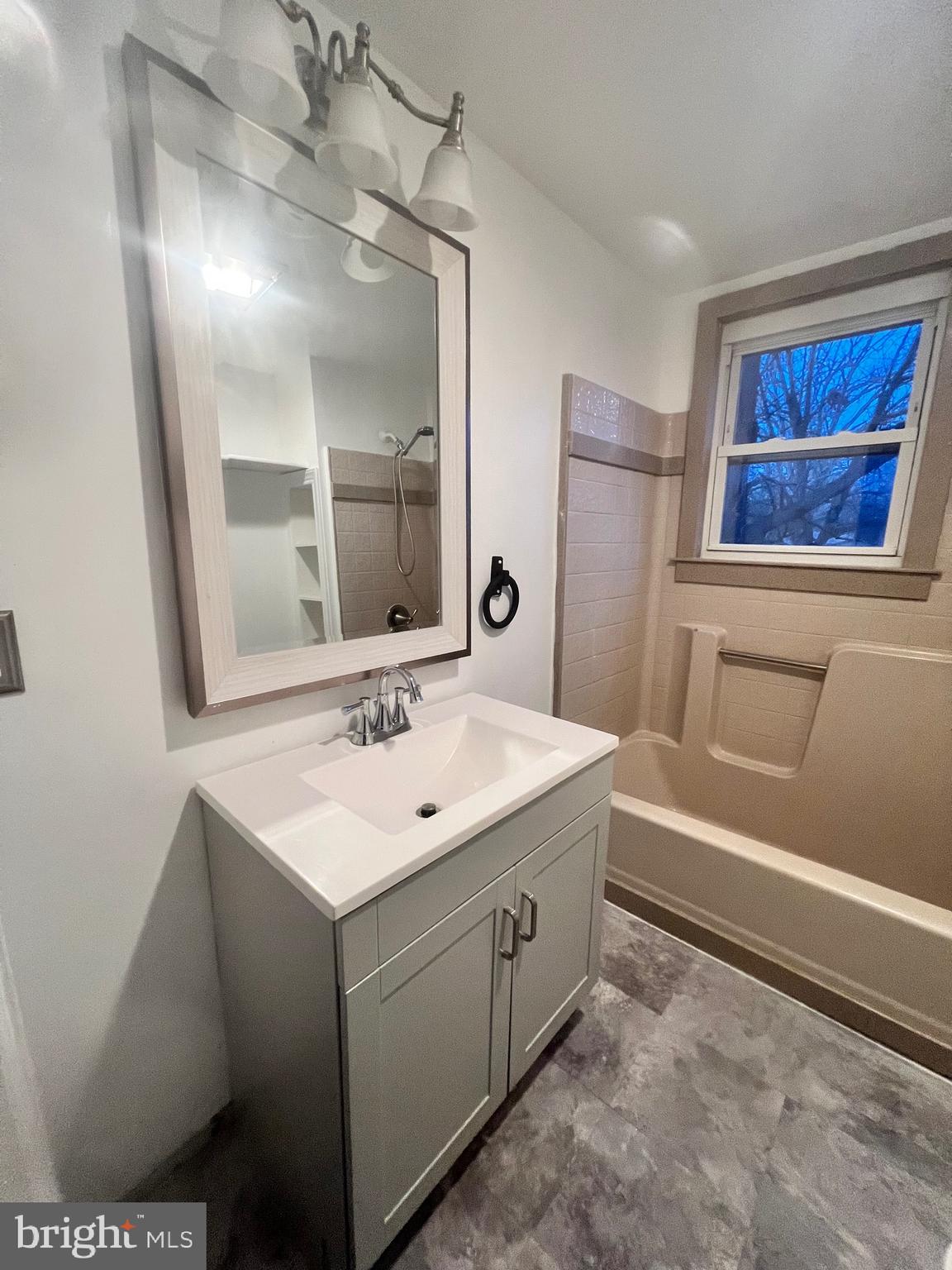 302 West Main Street Millville, NJ 08332 - Photo 13 of 22 a bathroom with a sink and a mirror