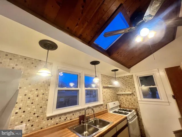 a bathroom with a sink a large mirror and a shower