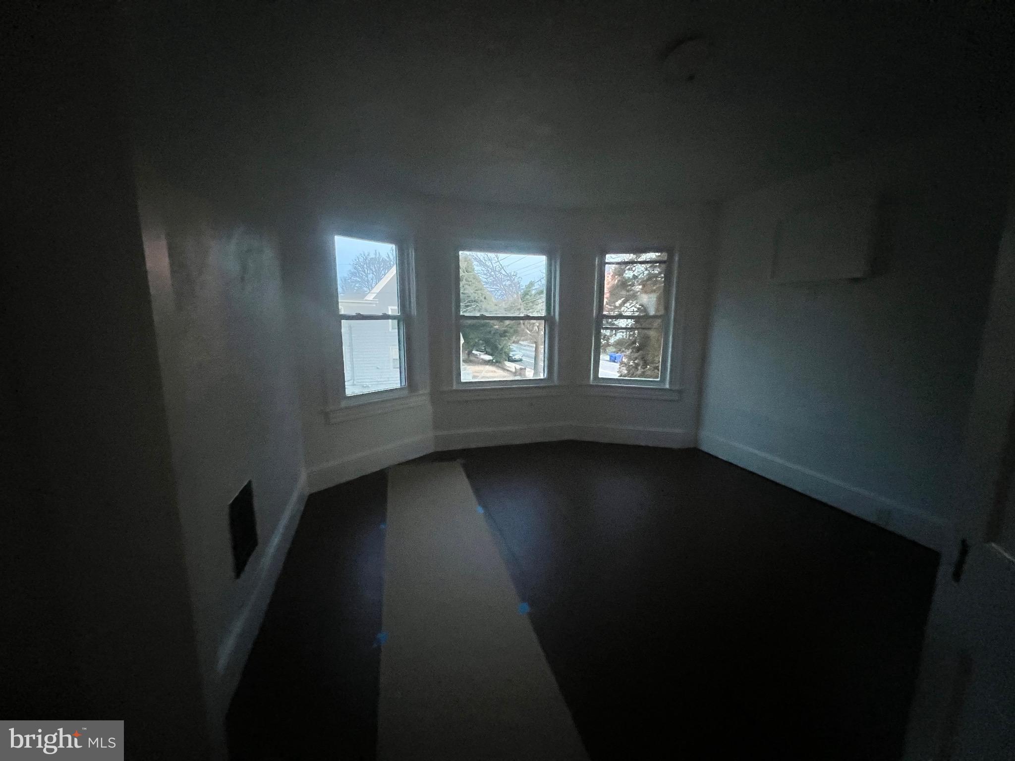 302 West Main Street Millville, NJ 08332 - Photo 20 of 22 a view of an empty room with wooden floor and a window